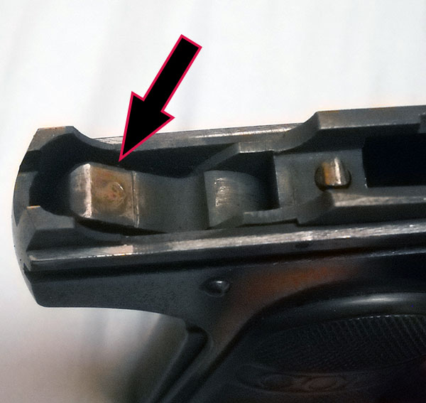 detail, Colt 1903 frame, with arrow indicating cocked hammer